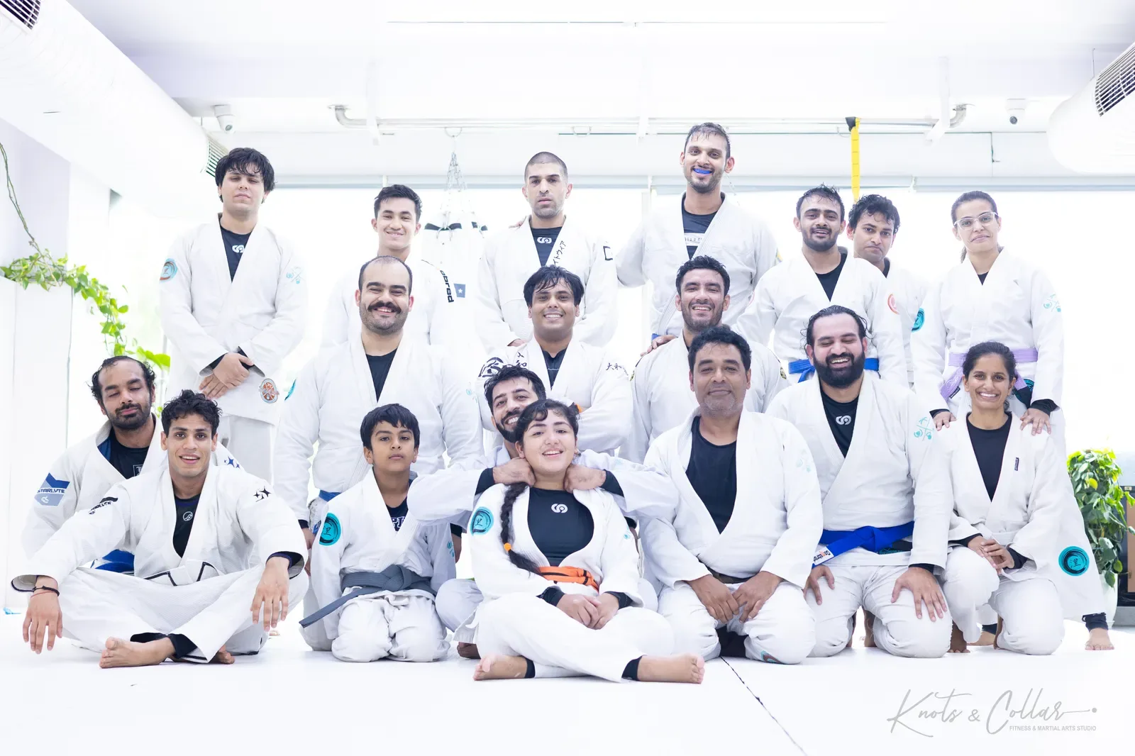 Adults and a young student of Knots & Collar together on the mat after a BJJ class in Defence Colony, New Delhi, India
