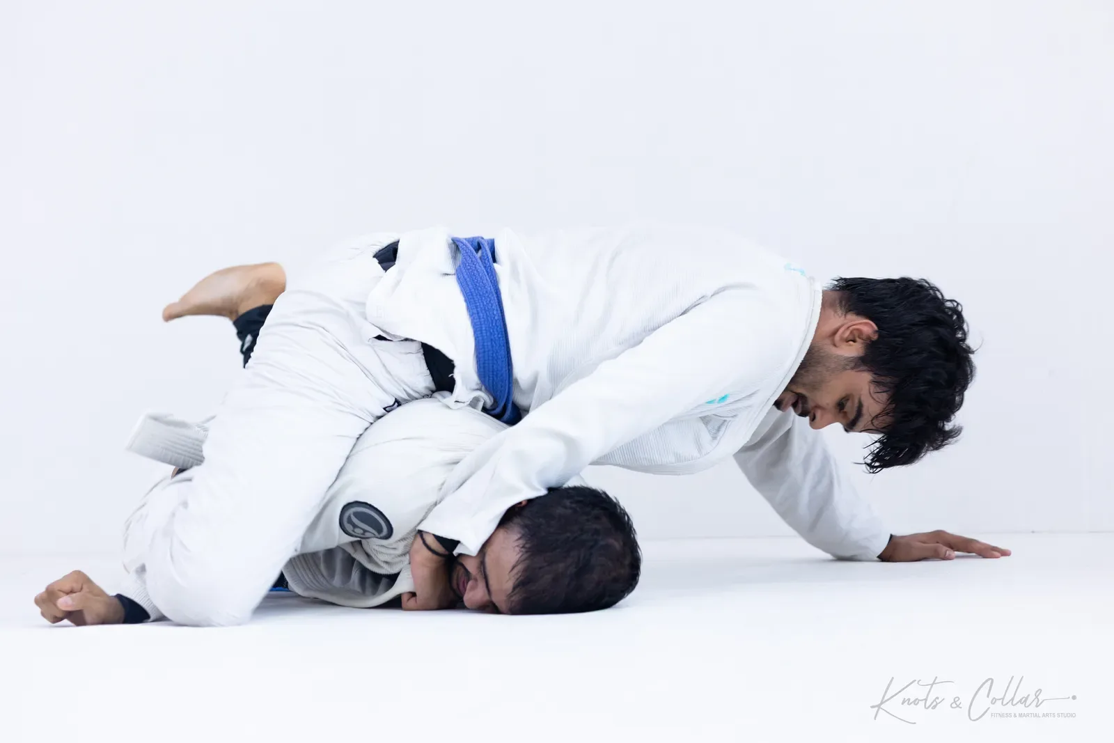 A student passing guard into top control during Brazilian jiu-jitsu training at Knots & Collar, Defence Colony, New Delhi