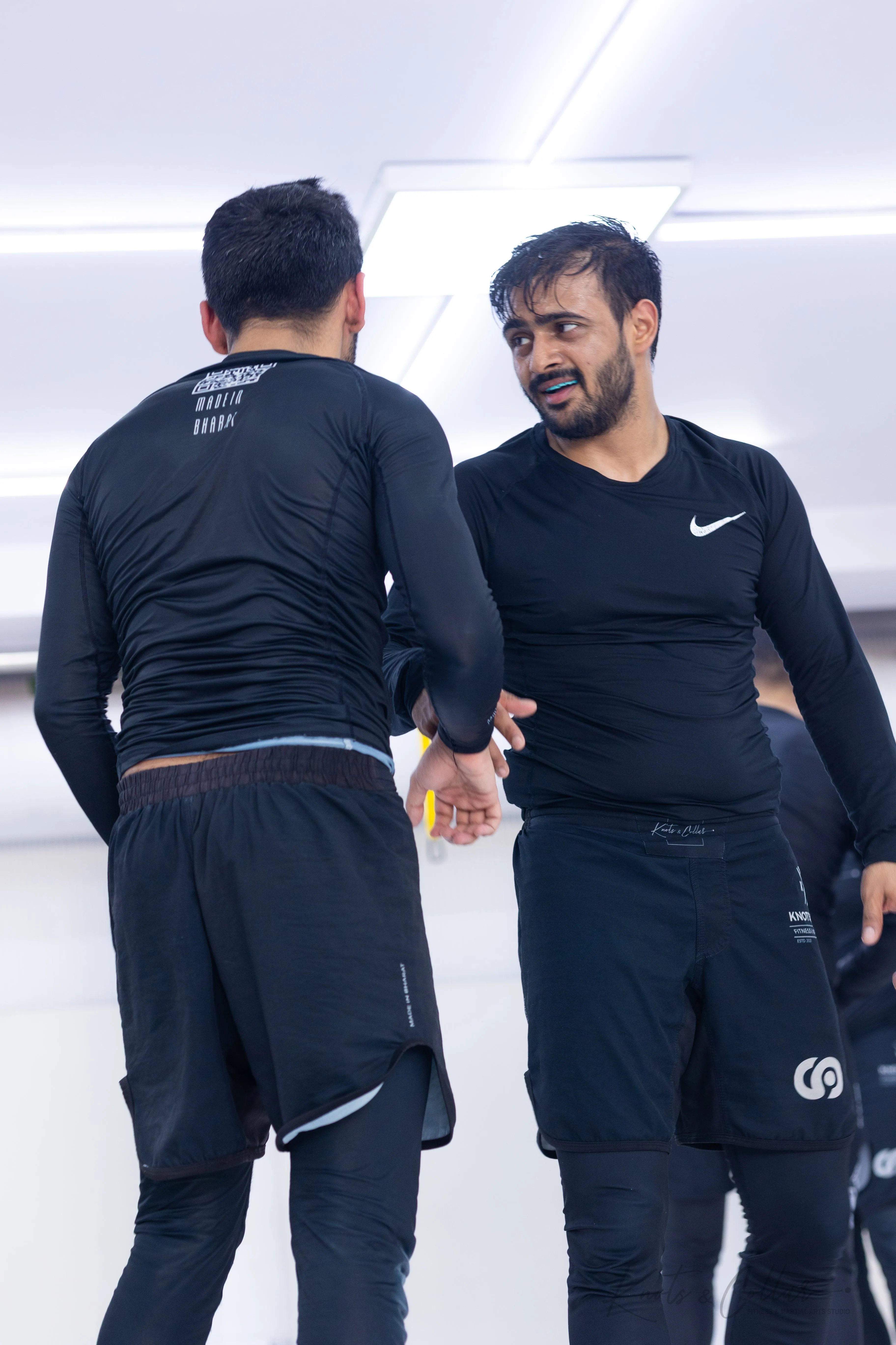 BJJ instructor mentoring a student, reflecting the Kindness Over Toughness teaching philosophy