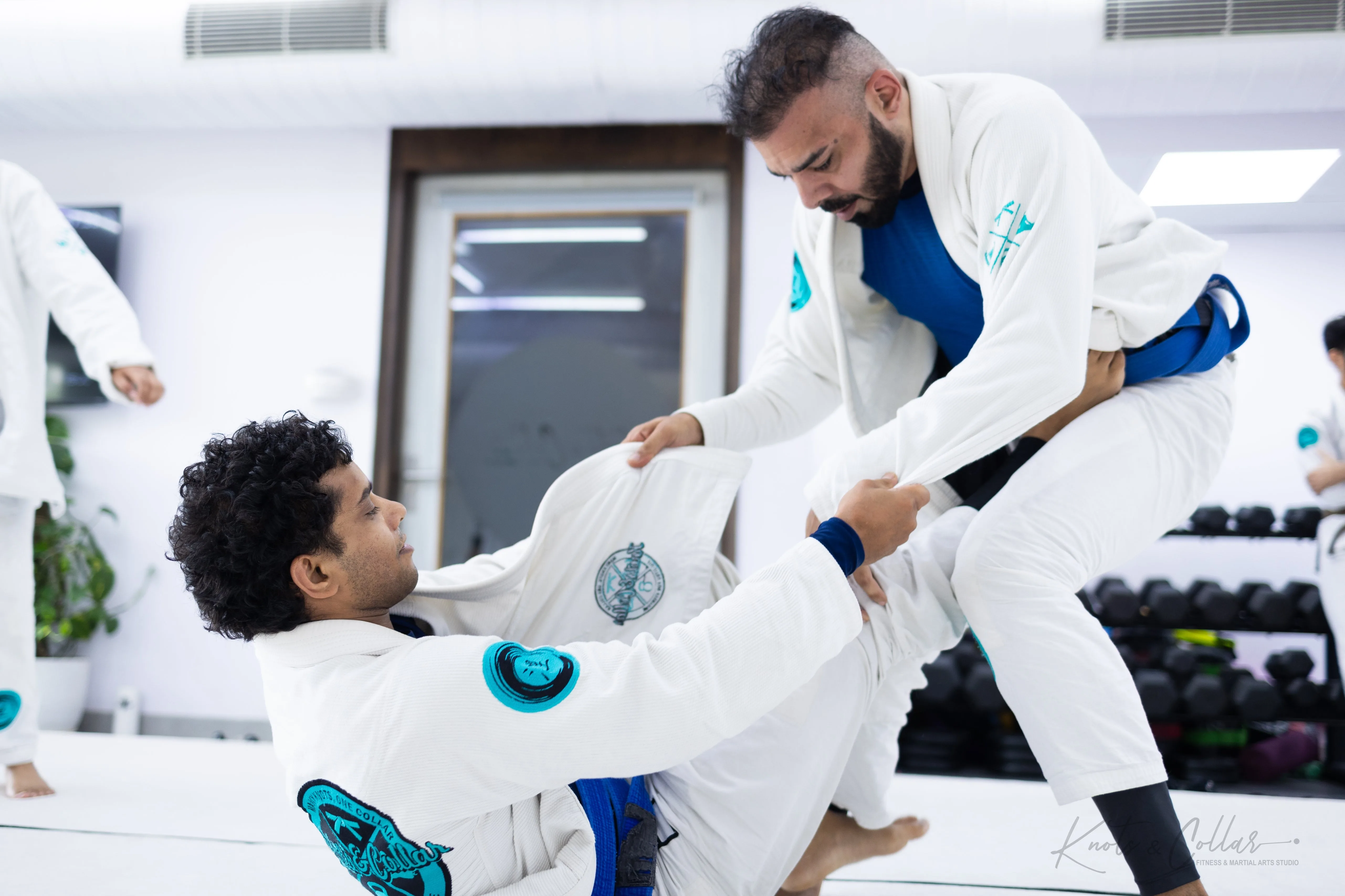 BJJ sparring session illustrating the strength and conditioning benefits of jiu-jitsu training