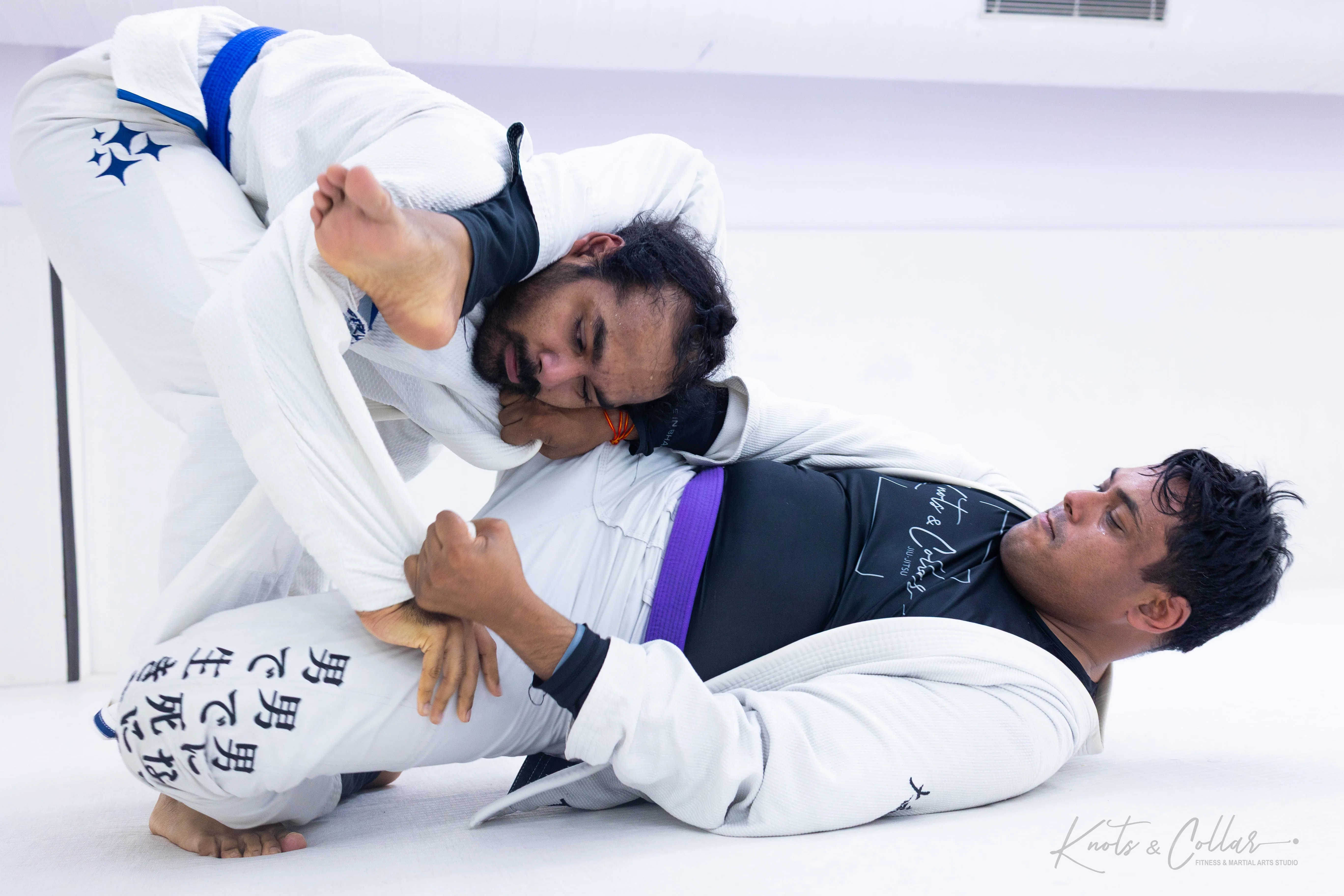 BJJ practitioners training a submission technique during a live grappling session