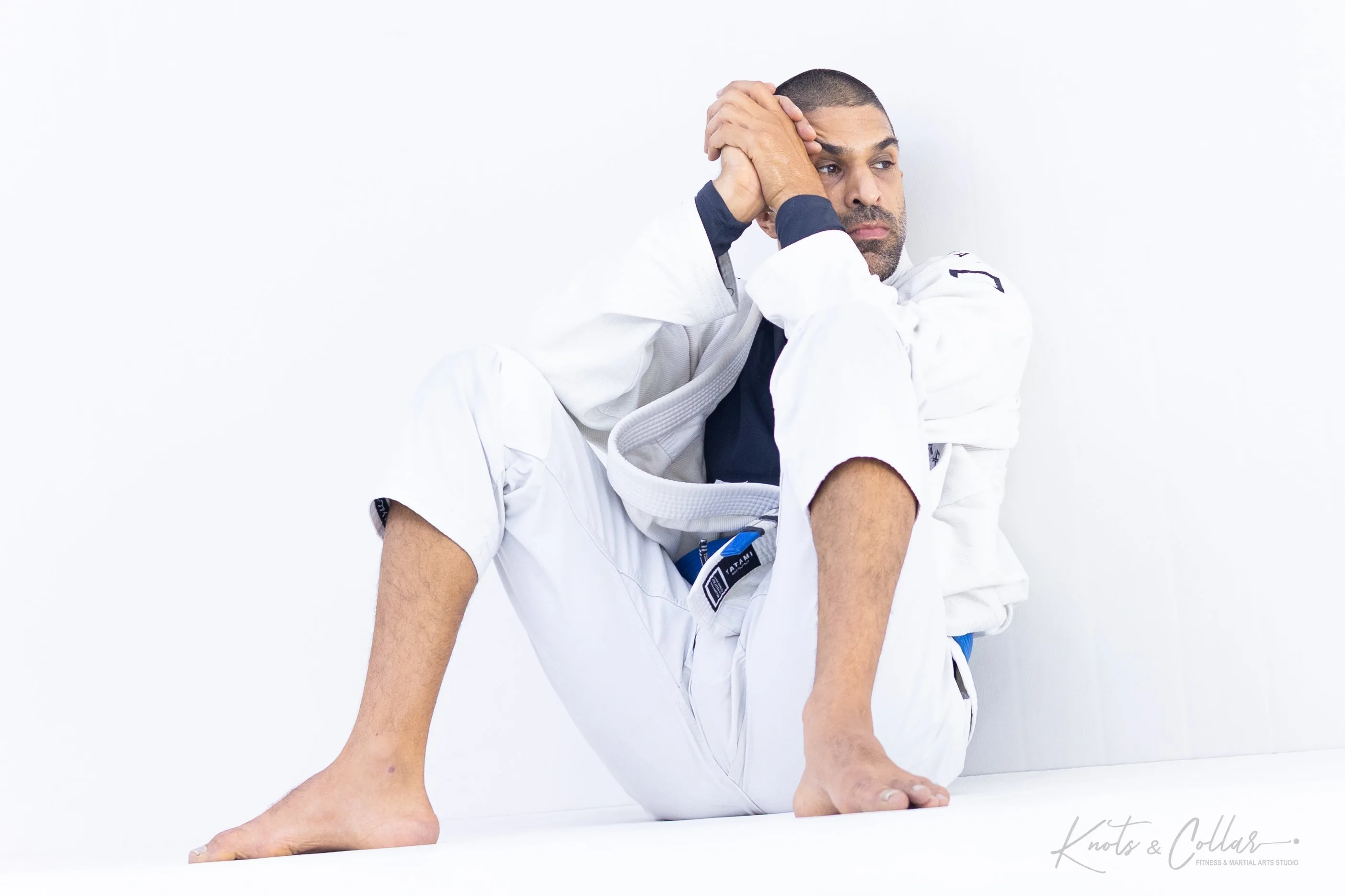 BJJ practitioner in gi studying guard position at Knots and Collar New Delhi