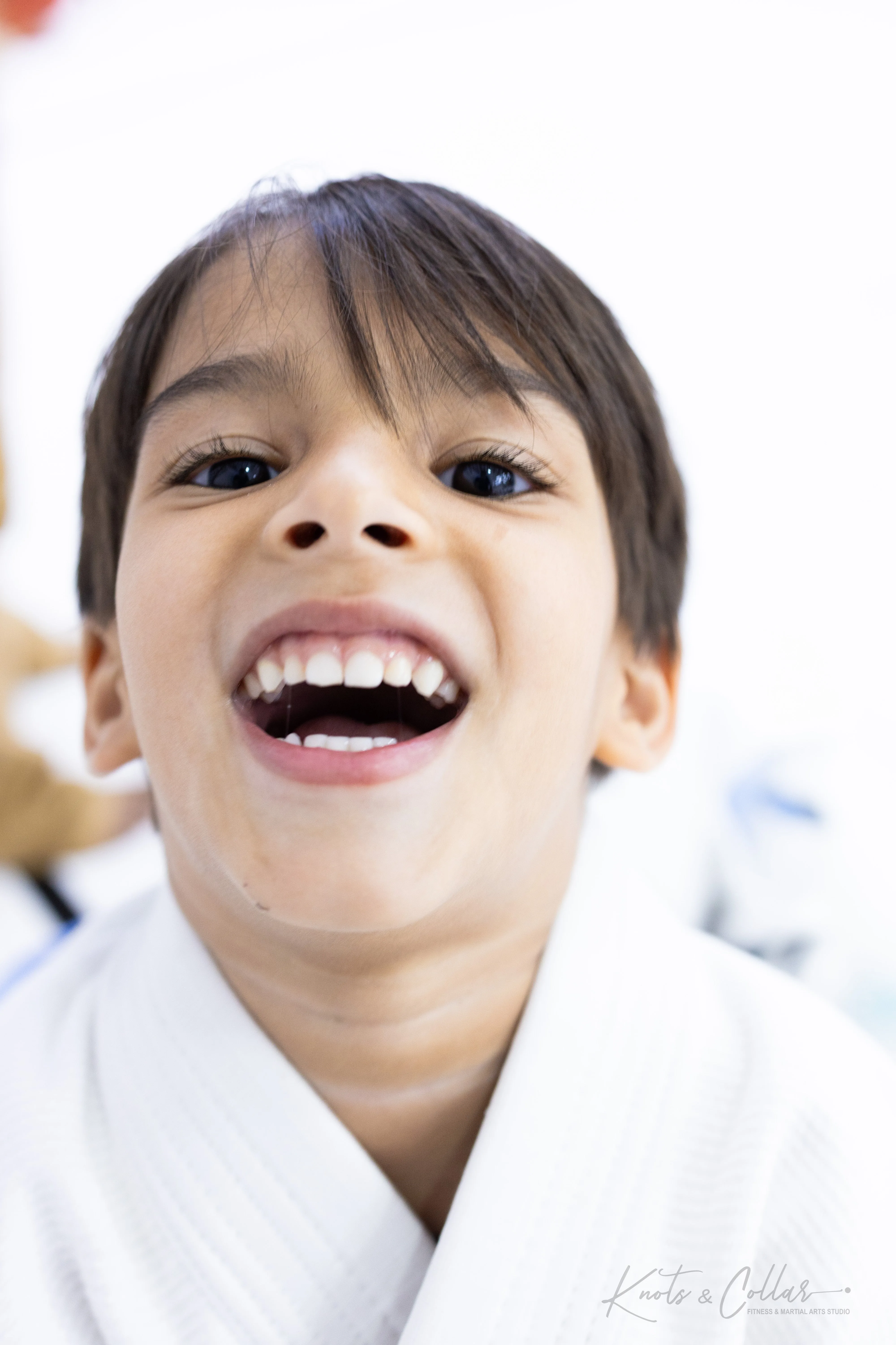 Happy young boy in BJJ gi at Knots and Collar kids class Defence Colony New Delhi