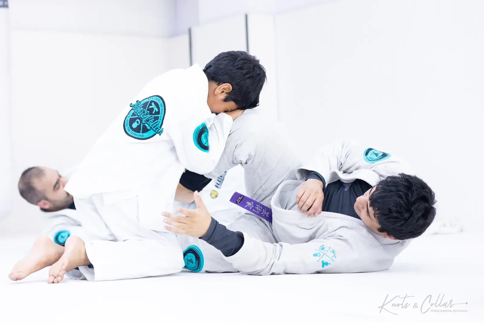 A young student taking top position on a purple belt in Brazilian Jiu-Jitsu at Knots & Collar, India