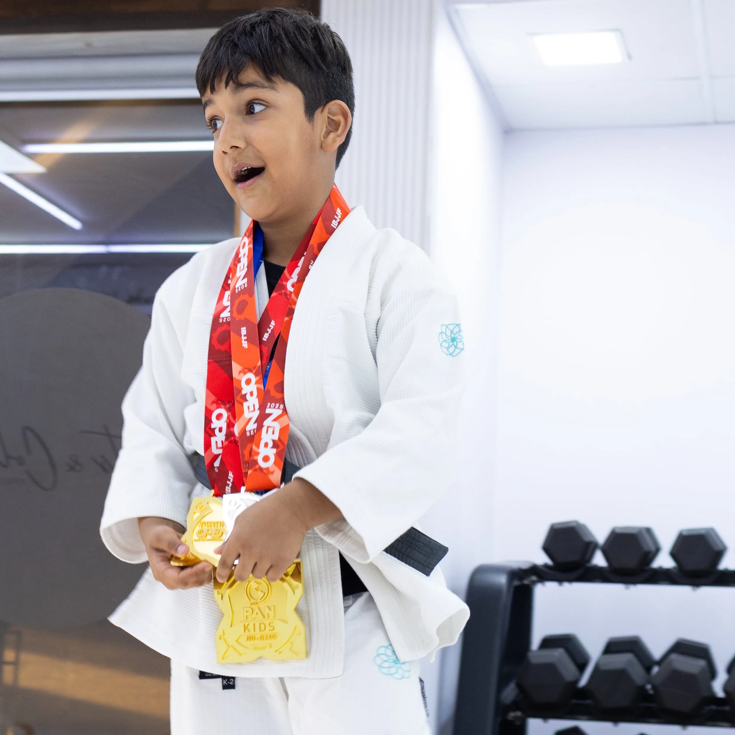 Young boy winning gold medal at kids BJJ competition Knots and Collar Defence Colony Delhi