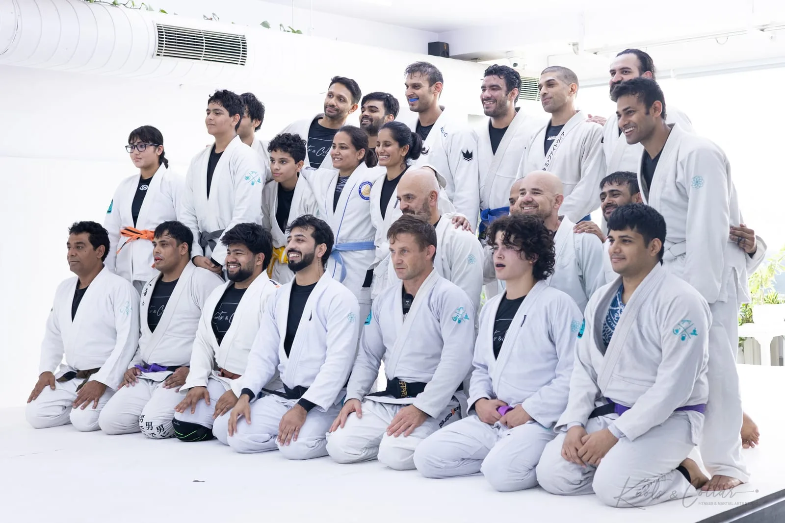 Brazilian jiu-jitsu students of every belt at Knots & Collar, New Delhi, photographed with Judo black belt Professor Jad Strutzel at the end of the class and live rounds