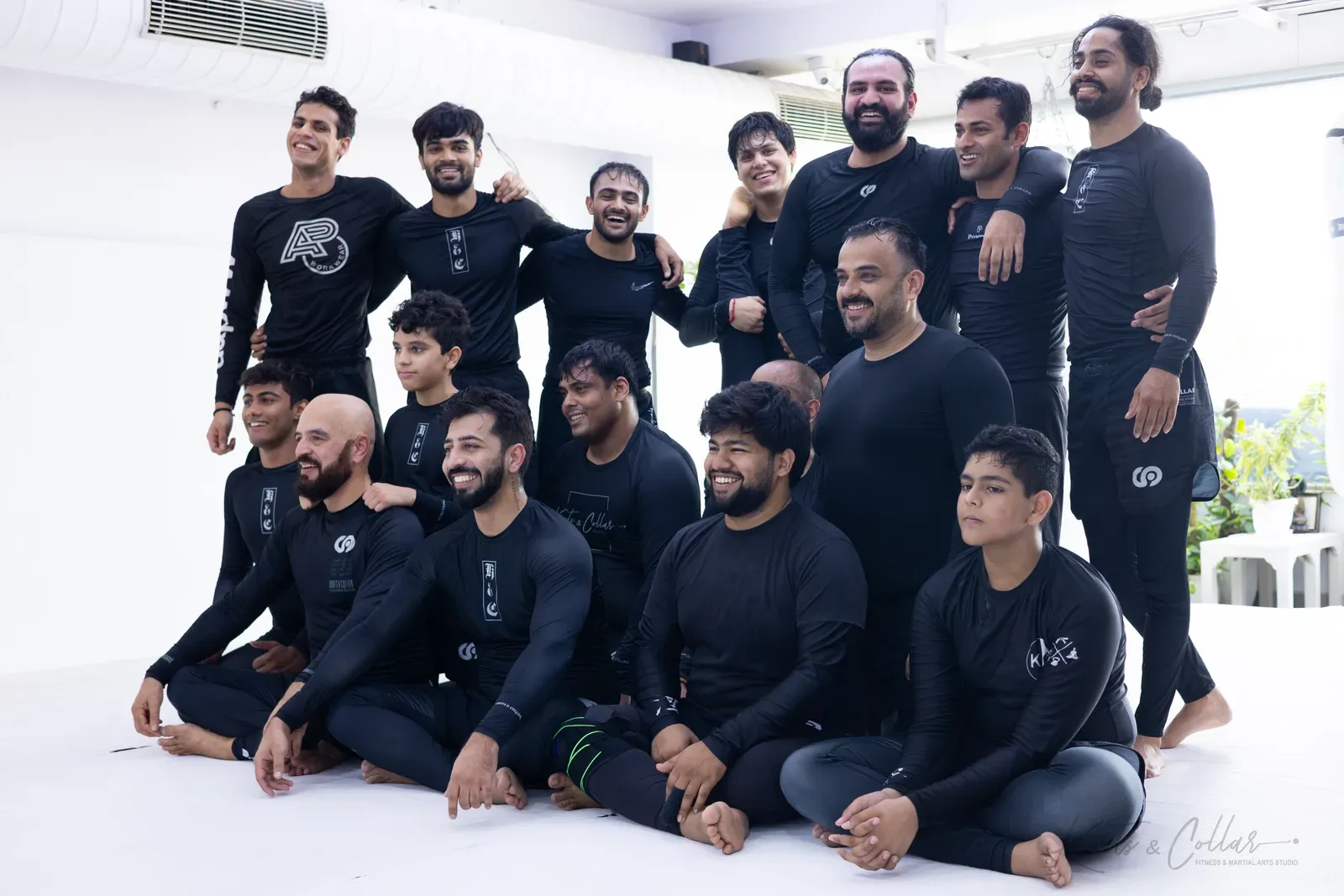 No-Gi Brazilian Jiu-Jitsu students at Knots & Collar in Delhi, India, smiling on the mat after a Saturday class