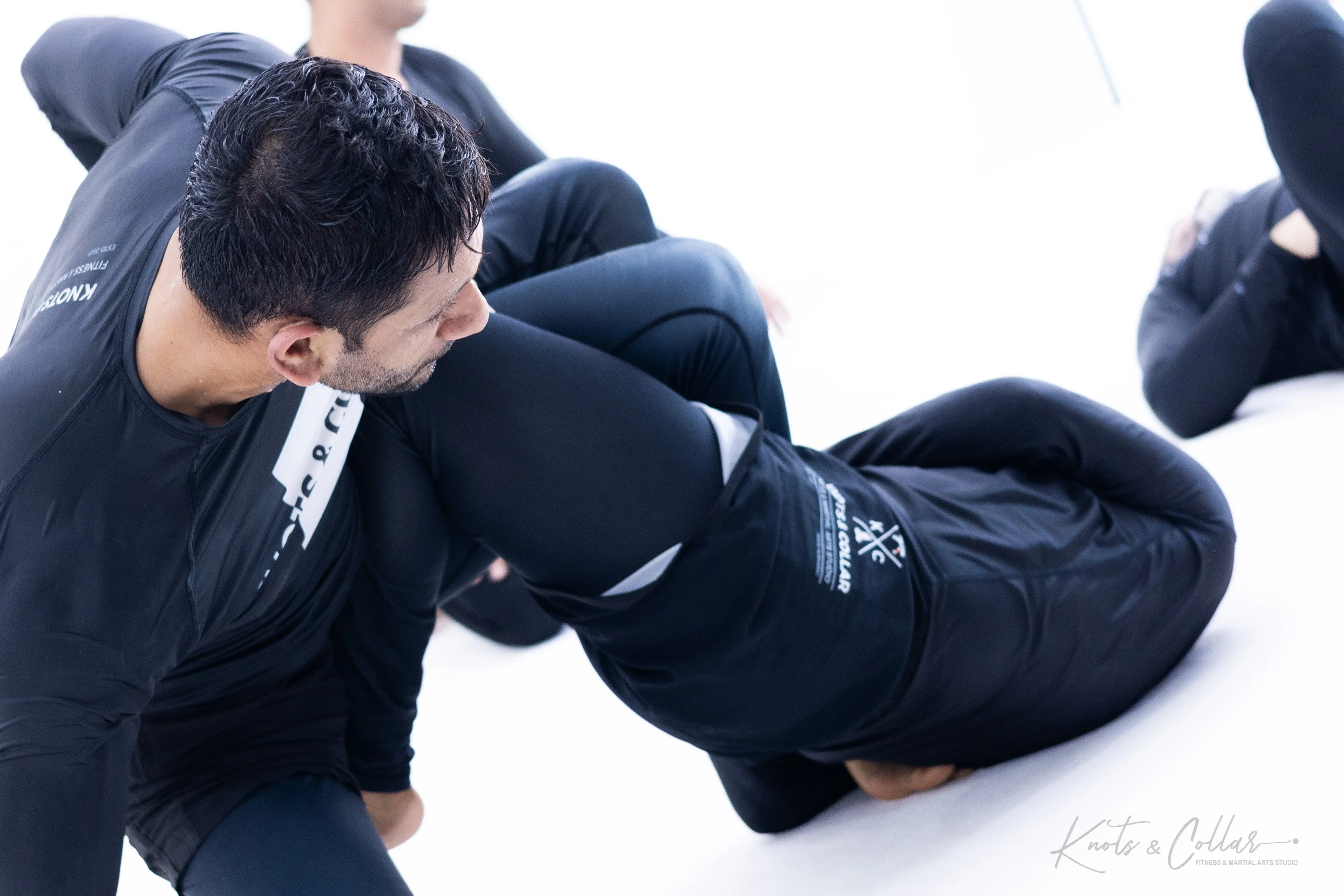 No-gi BJJ grappling exchange demonstrating full-body conditioning