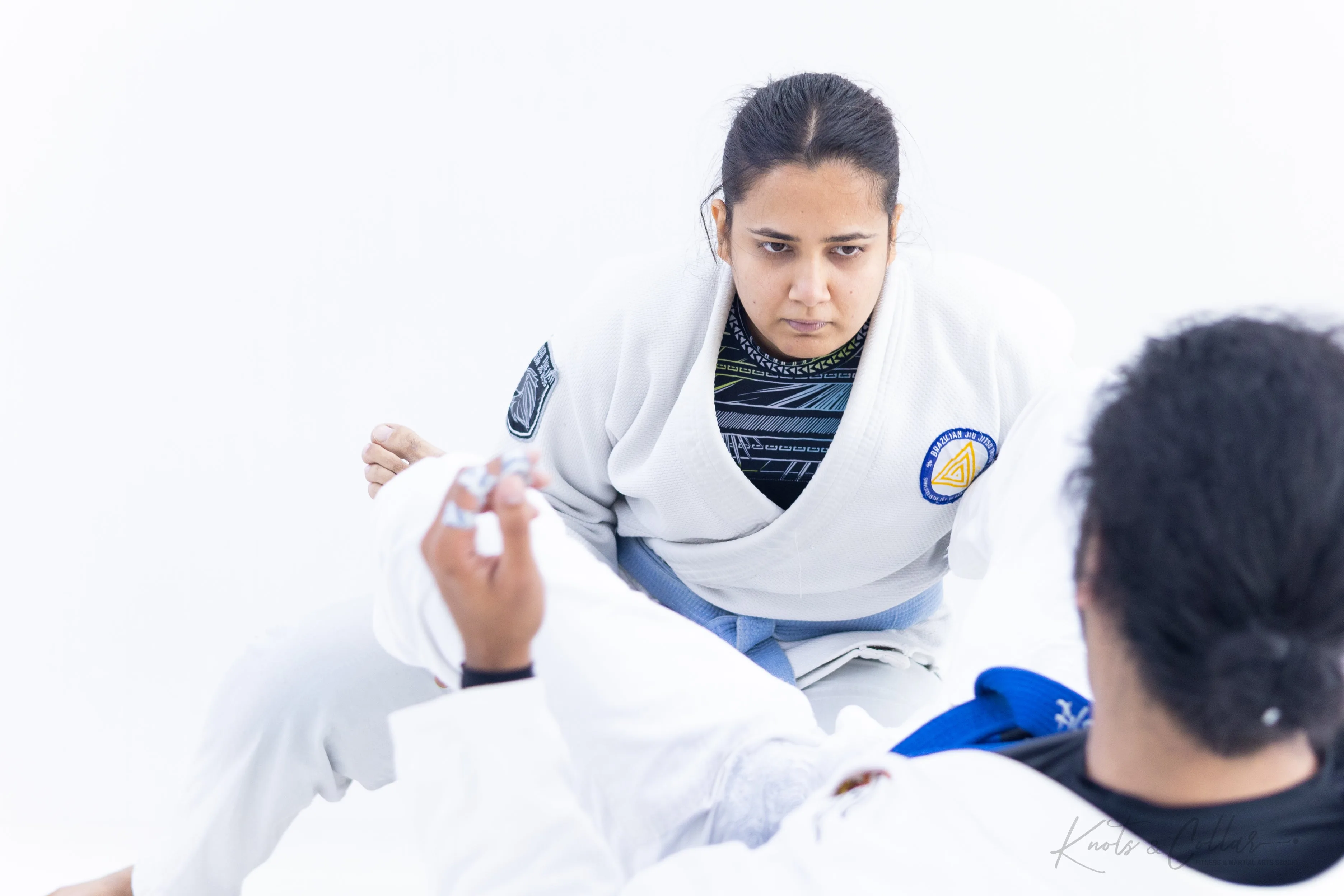 Woman learning BJJ technique in gi class at Knots and Collar Defence Colony New Delhi
